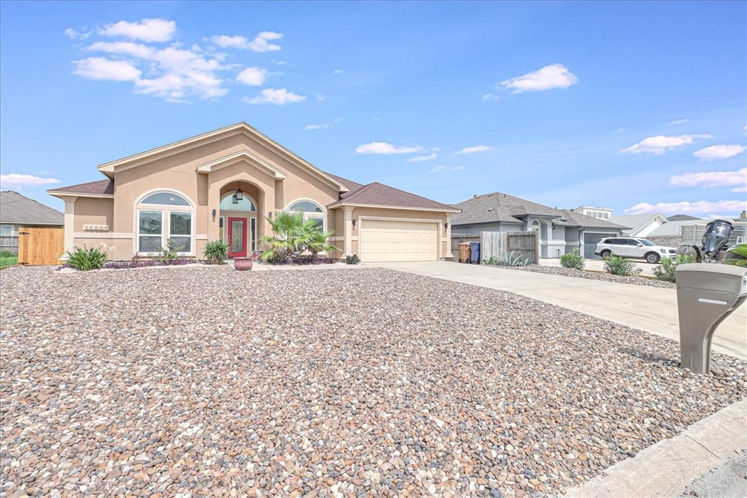 15501 Escapade Street Corpus Christi, TX 78418 - Photo 7 of 40 a front view of a house with a yard