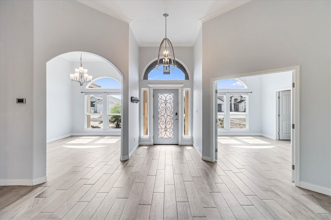 15501 Escapade Street Corpus Christi, TX 78418 - Photo 8 of 40 a view of a hallway with wooden floor and a chandelier