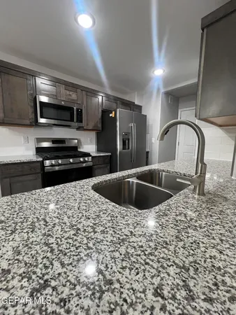 a kitchen with a sink a stove and refrigerator
