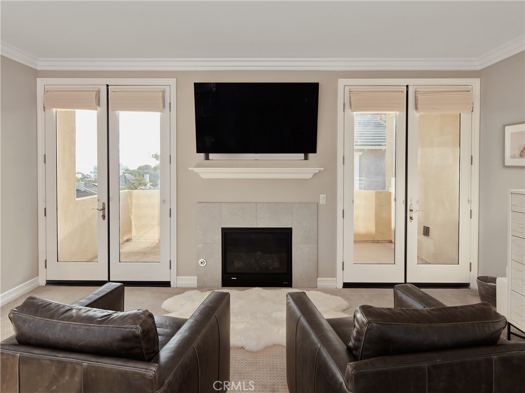 700 West Sycamore Avenue El Segundo, CA 90245 - Photo 25 of 42 a living room with furniture a fireplace and a flat screen tv