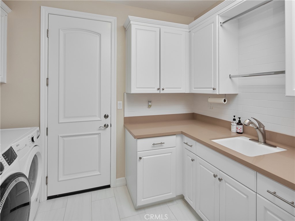 700 West Sycamore Avenue El Segundo, CA 90245 - Photo 40 of 42 a view of a storage and utility room with dryer and washer