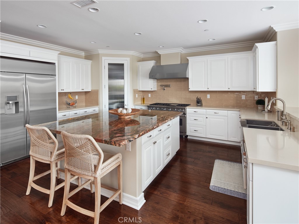 700 West Sycamore Avenue El Segundo, CA 90245 - Photo 9 of 42 a kitchen with stainless steel appliances granite countertop a white cabinets and wooden floor