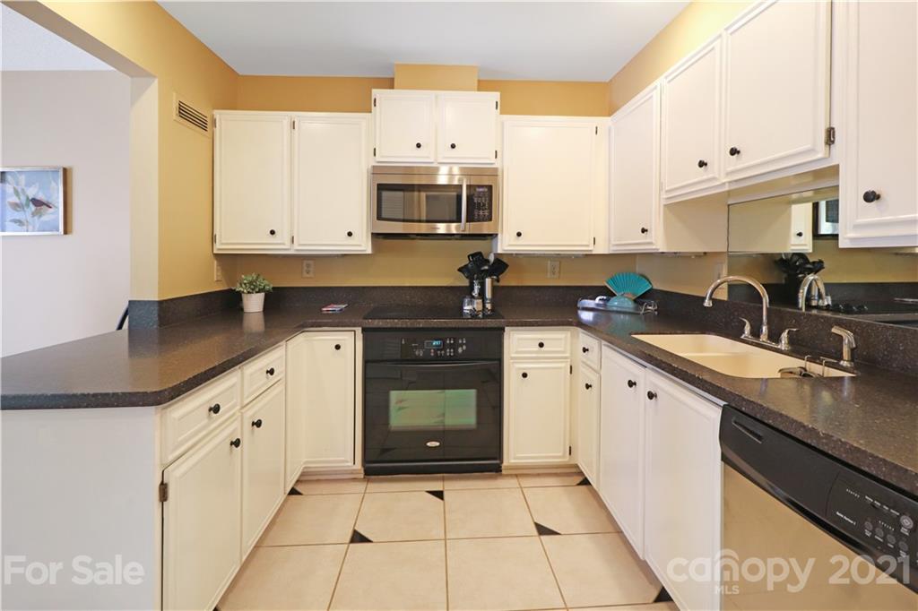 64 Ridgeport Road Lake Wylie, SC 29710 - Photo 14 of 37 a kitchen with stainless steel appliances granite countertop a sink a stove a microwave and a refrigerator