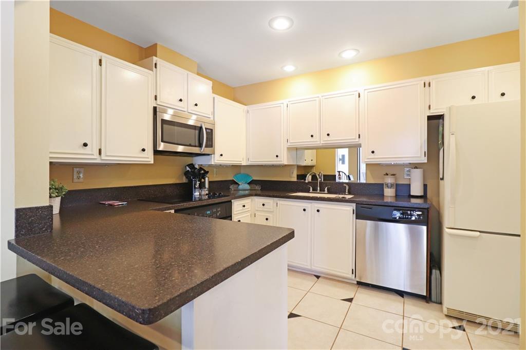 64 Ridgeport Road Lake Wylie, SC 29710 - Photo 15 of 37 a kitchen with stainless steel appliances a refrigerator sink stove microwave and cabinets