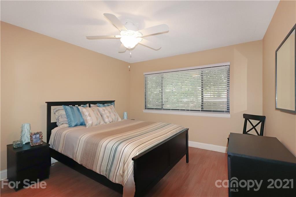 64 Ridgeport Road Lake Wylie, SC 29710 - Photo 17 of 37 a bedroom with a bed and a lamp on dresser
