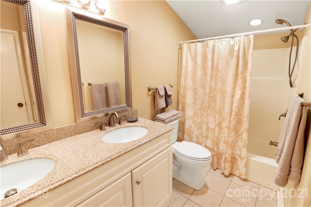 64 Ridgeport Road Lake Wylie, SC 29710 - Photo 21 of 37 a bathroom with a granite countertop sink a toilet and a mirror