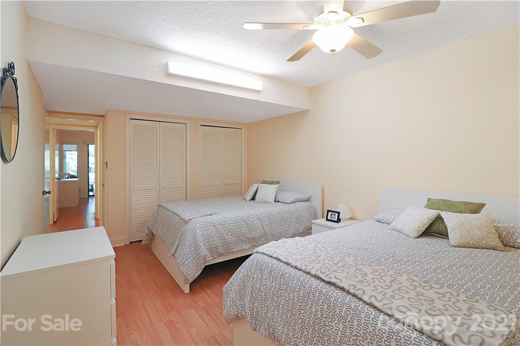 64 Ridgeport Road Lake Wylie, SC 29710 - Photo 28 of 37 a bedroom with two beds and a chandelier