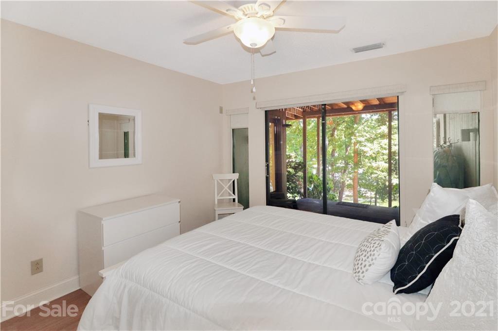64 Ridgeport Road Lake Wylie, SC 29710 - Photo 30 of 37 a bedroom with a bed and a chandelier