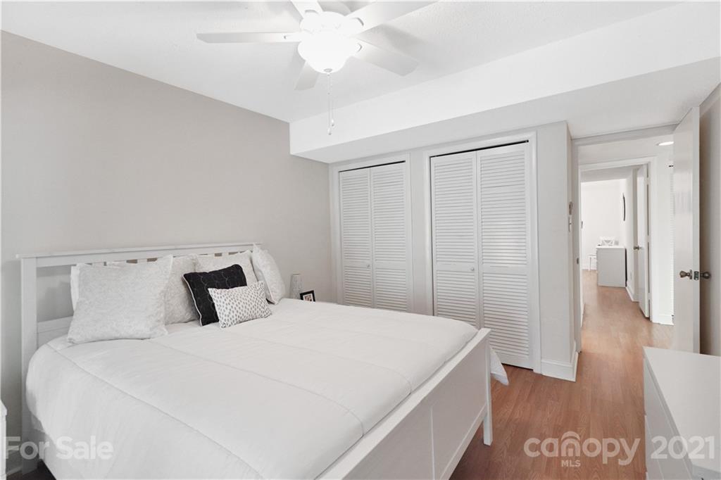 64 Ridgeport Road Lake Wylie, SC 29710 - Photo 31 of 37 a bedroom with a large bed and a chandelier