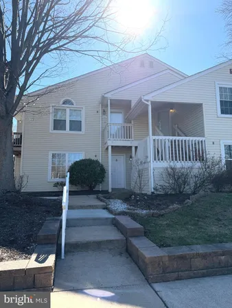 a sign that is sitting in front of flowers
