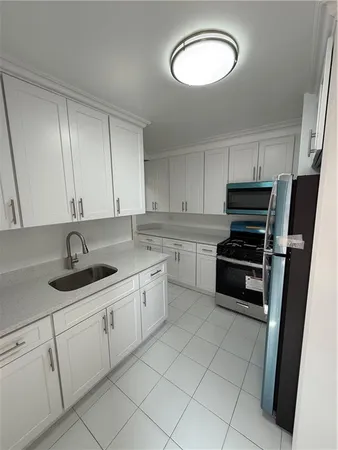 a kitchen with appliances cabinets and a sink