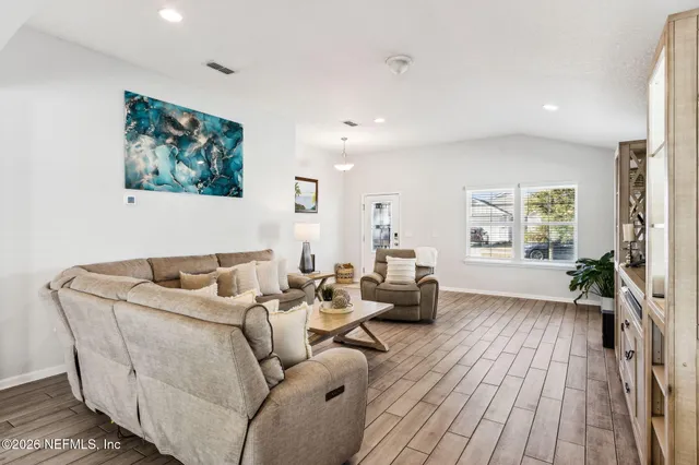 a view of a dining room with furniture and wooden floor