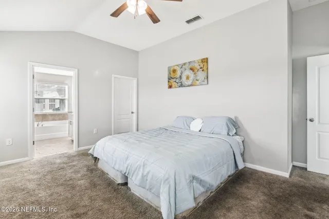 a bathroom with a tub a sink and a large mirror