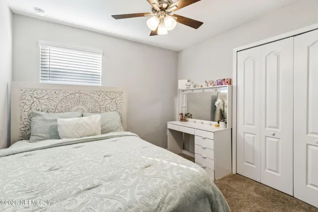 a front view of house with yard and trees in the background