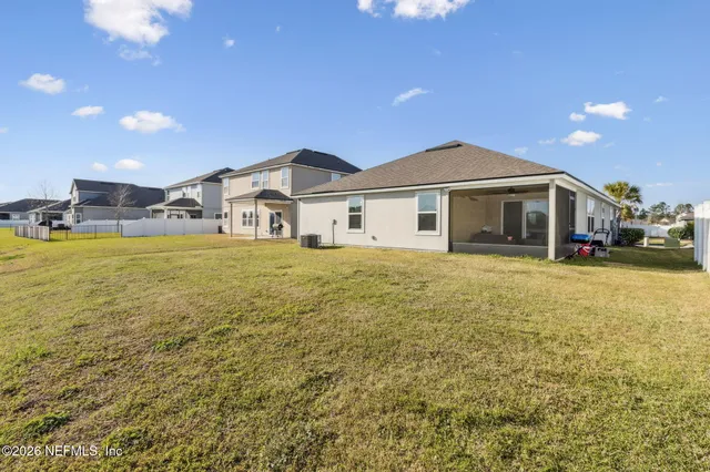 an aerial view of residential house with pool and yard