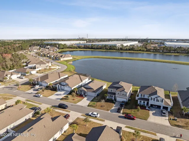 an aerial view of a house with a lake view