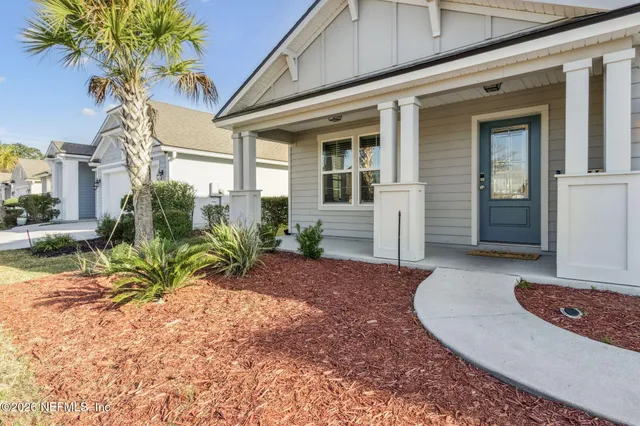 a view of a house with a small yard and plants
