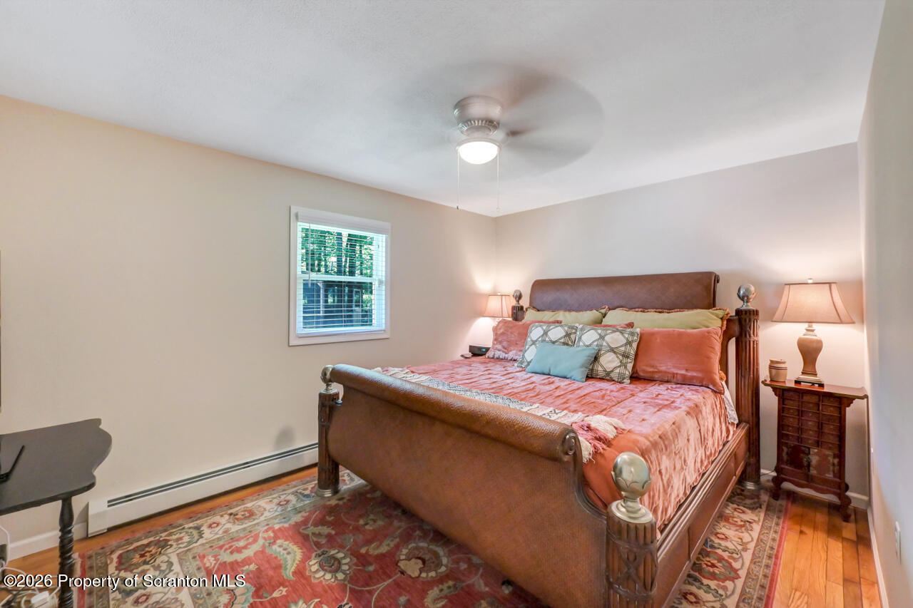 3660 Aberdeen Road Moscow, PA 18444 - Photo 35 of 68 a bedroom with a bed and wooden floor