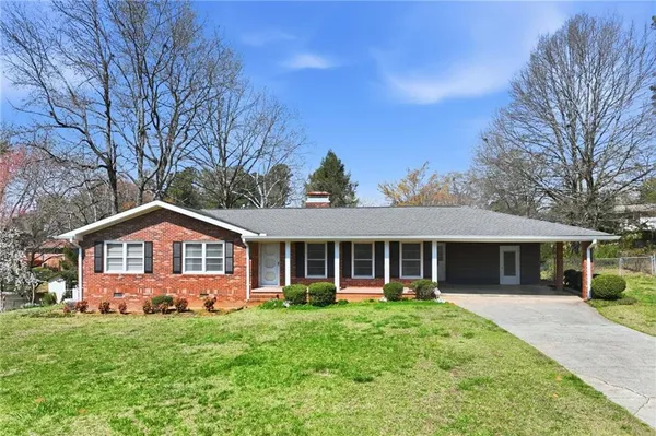a front view of a house with a yard and porch