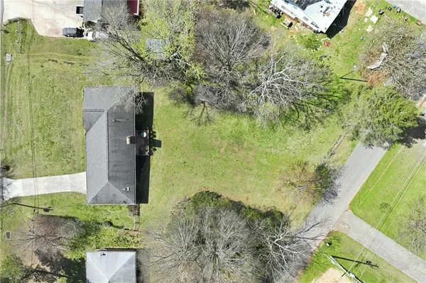 a aerial view of a residential houses with yard