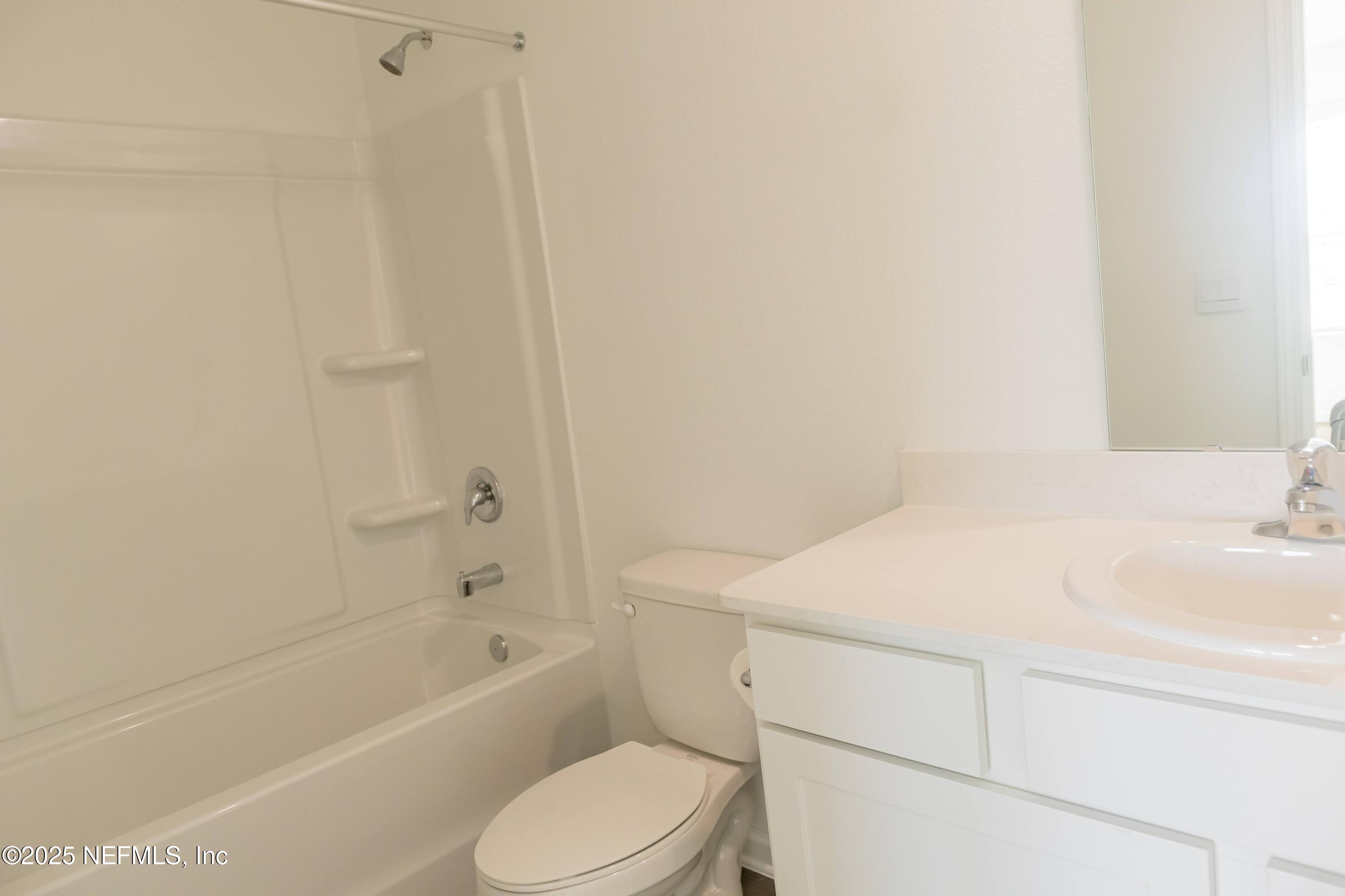 1700 Bridger Trace Middleburg, FL 32068 - Photo 11 of 14 a bathroom with a sink a toilet and bathtub