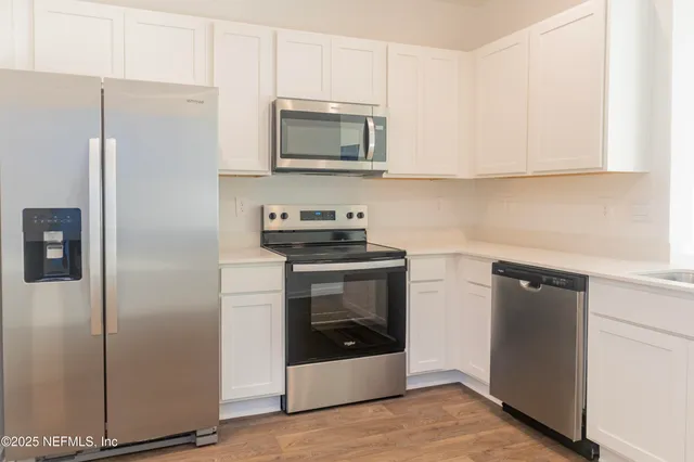 a kitchen with a refrigerator stove and microwave