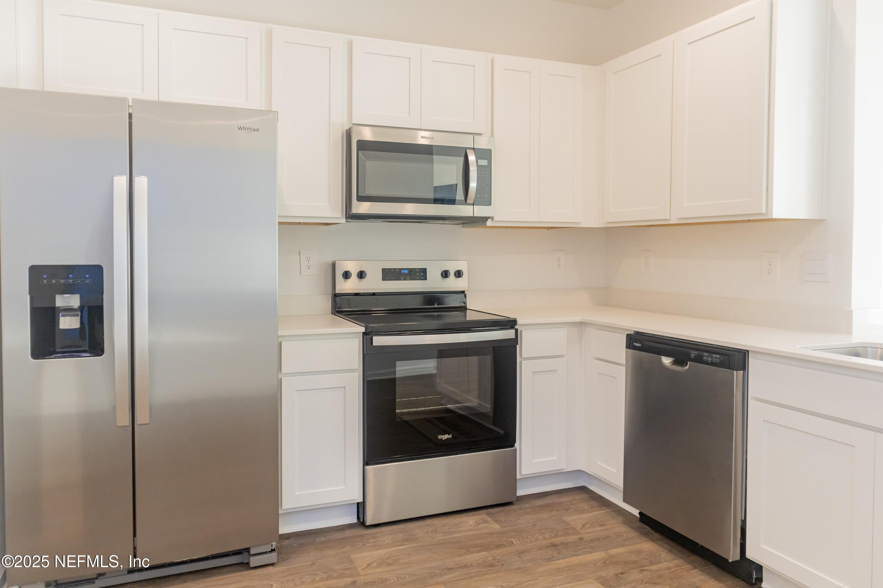 1700 Bridger Trace Middleburg, FL 32068 - Photo 2 of 14 a kitchen with a refrigerator stove and microwave