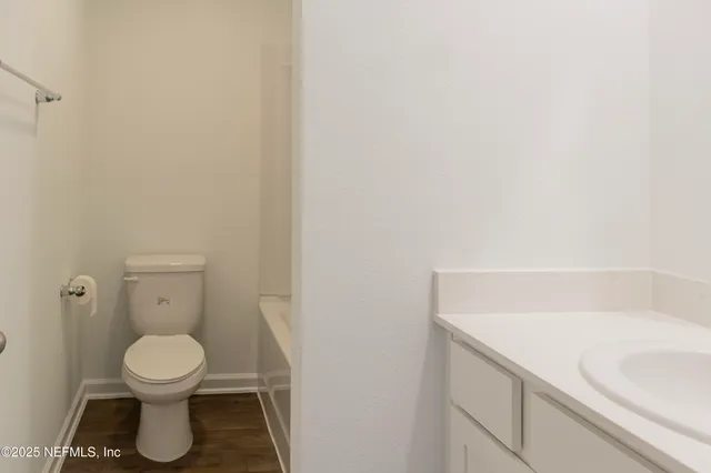 a bathroom with a toilet and a rug