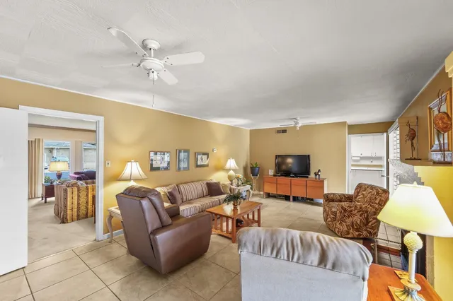 a spacious bedroom with a bed and glass walk in closet