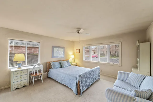 a spacious bedroom with a bed and wooden floor