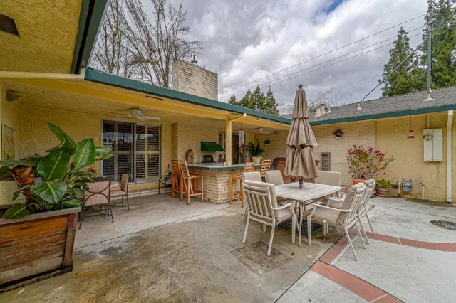 a living room with stainless steel appliances furniture and a window