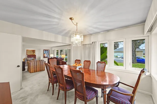 a view of a dining room with furniture wooden floor and chandelier