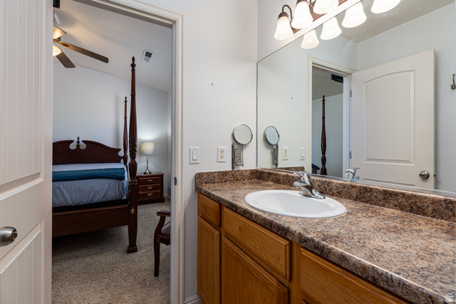 6 300th Road North, Unit I6 Kanab, UT 84741 - Photo 22 of 37 Ensuite bathroom with vanity, light carpet, and ceiling fan