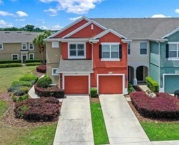 a front view of a house with a garden and plants