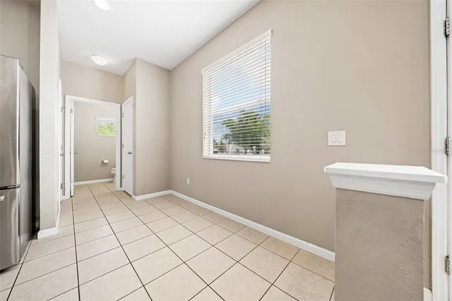 a view of an empty room with window and cabinet
