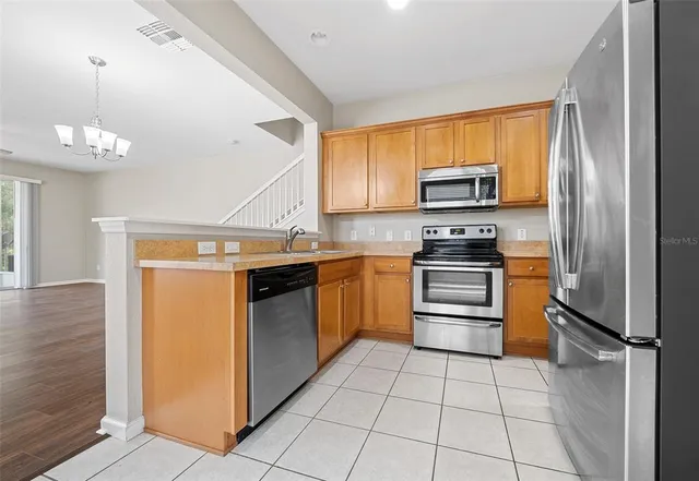 a kitchen with a stove sink and a refrigerator