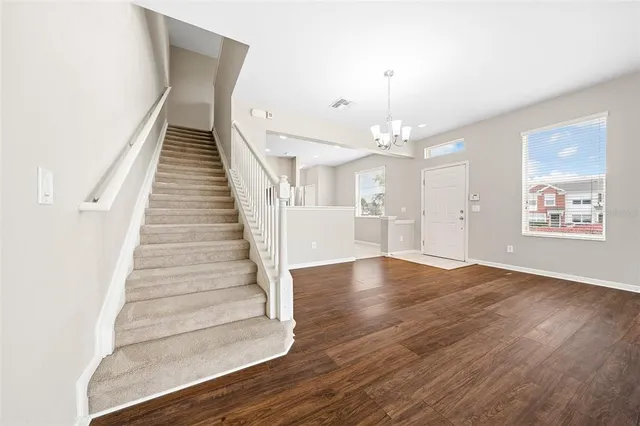a view of an entryway with wooden floor