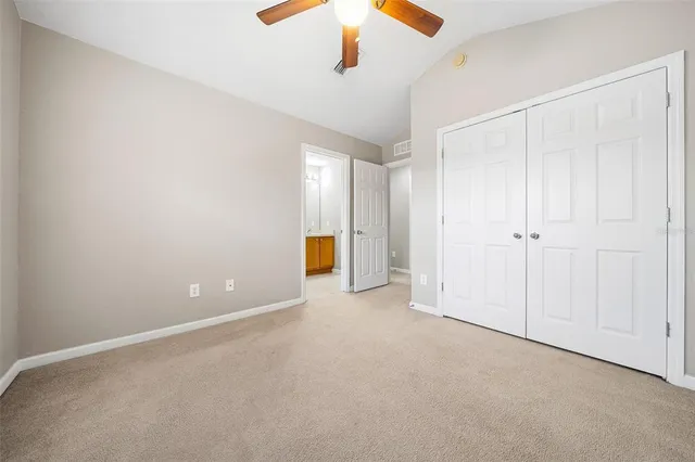a view of an empty room with a ceiling fan
