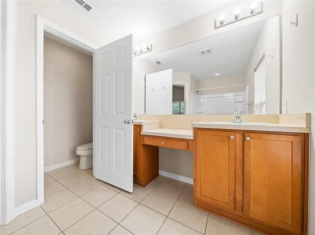 a room with stainless steel appliances a sink and a refrigerator