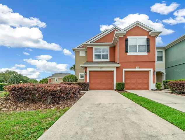 a front view of a house with a yard and garage
