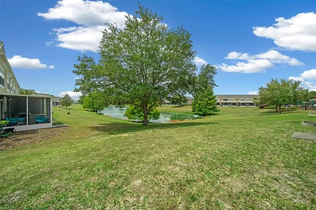 a view of a field of grass and trees