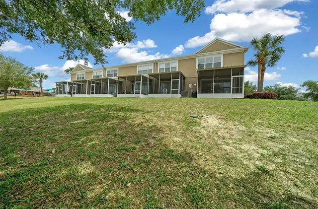 a view of a big yard with plants and large trees