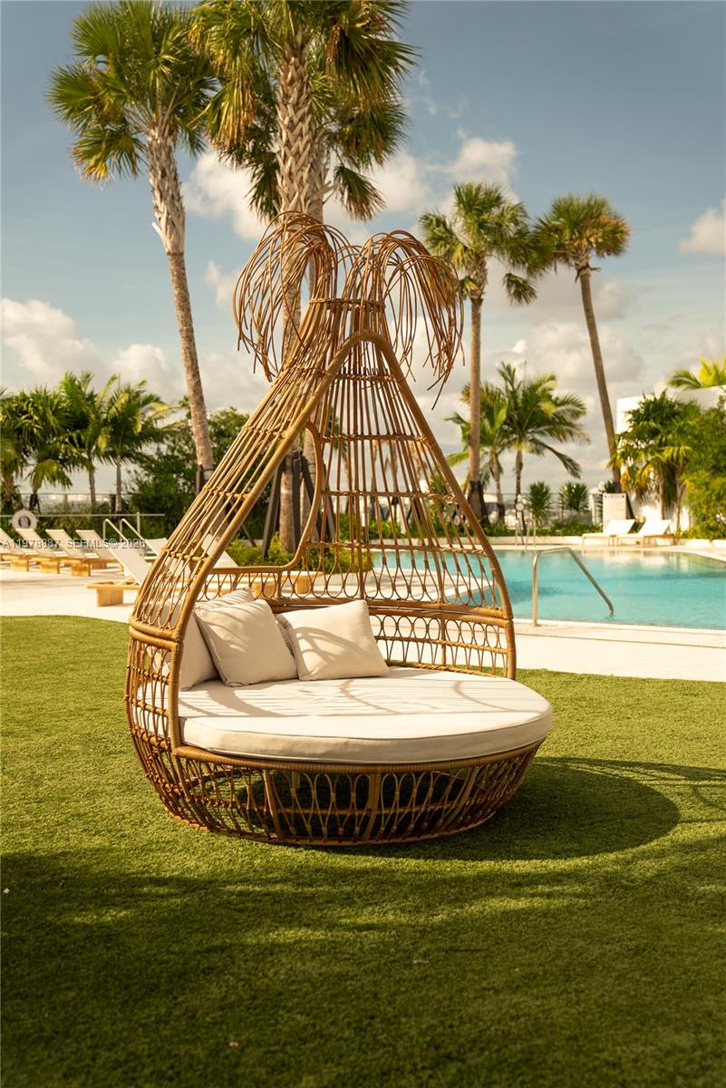 275 Southwest 6th Street, Unit 2007 Miami, FL 33130 - Photo 19 of 24 a view of swimming pool with a table and chair