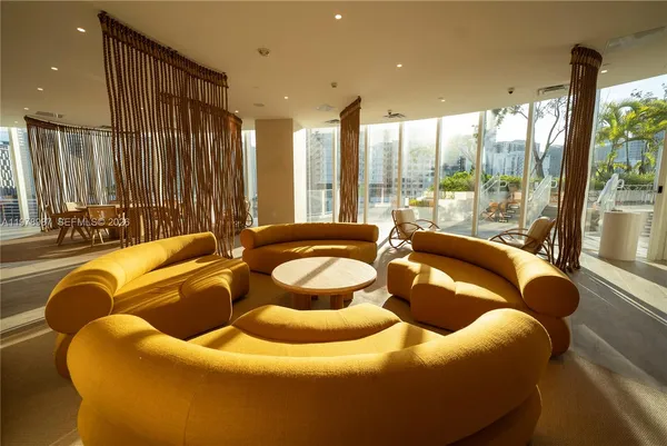 a large room with lots of chairs and mirrors