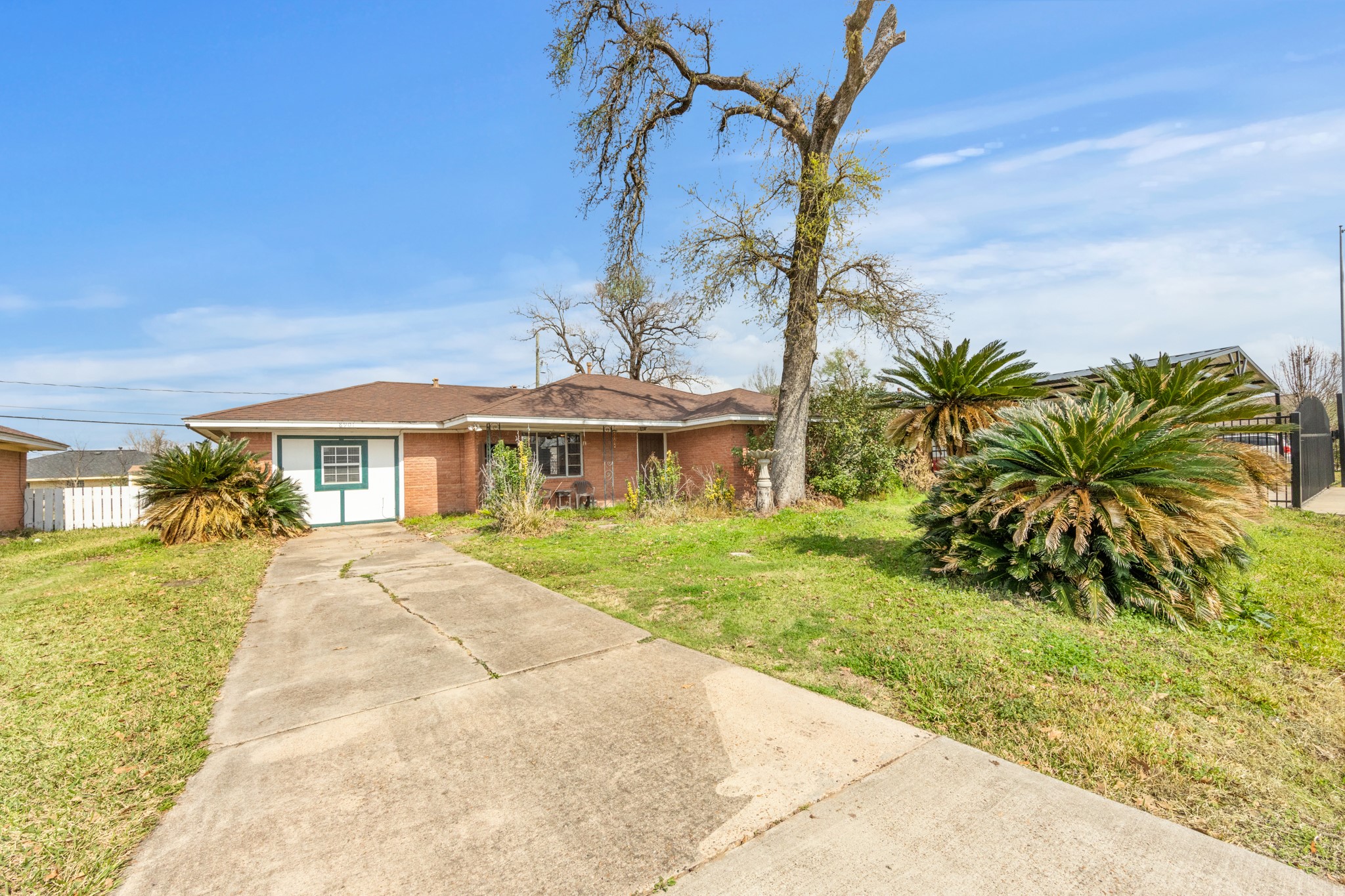 a front view of a house with a garden and yard