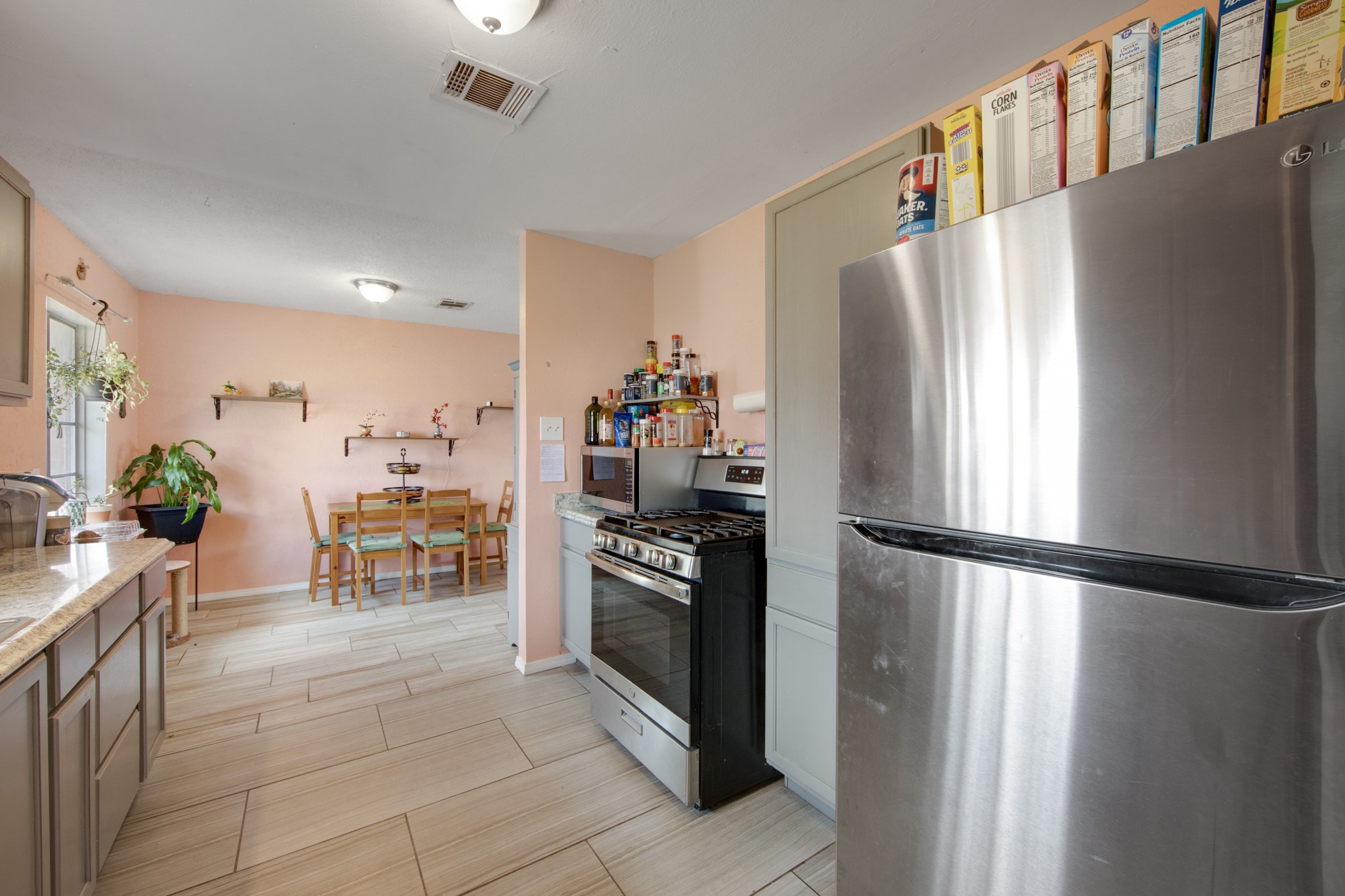 8901 Woodlyn Road Houston, TX 77078 - Photo 12 of 22 a kitchen with stainless steel appliances a refrigerator and a stove top oven
