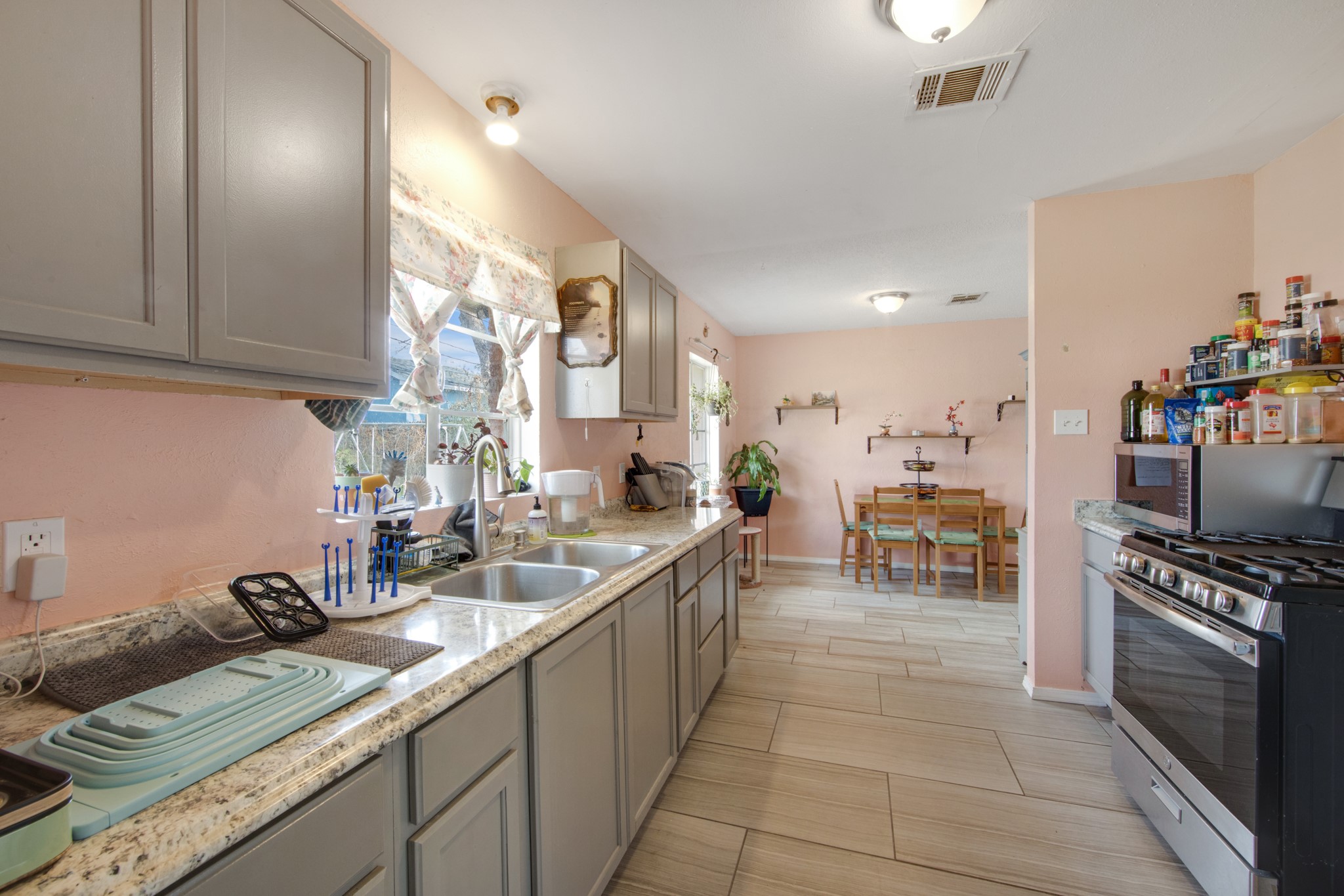 8901 Woodlyn Road Houston, TX 77078 - Photo 13 of 22 a kitchen with sink cabinets and stove top oven