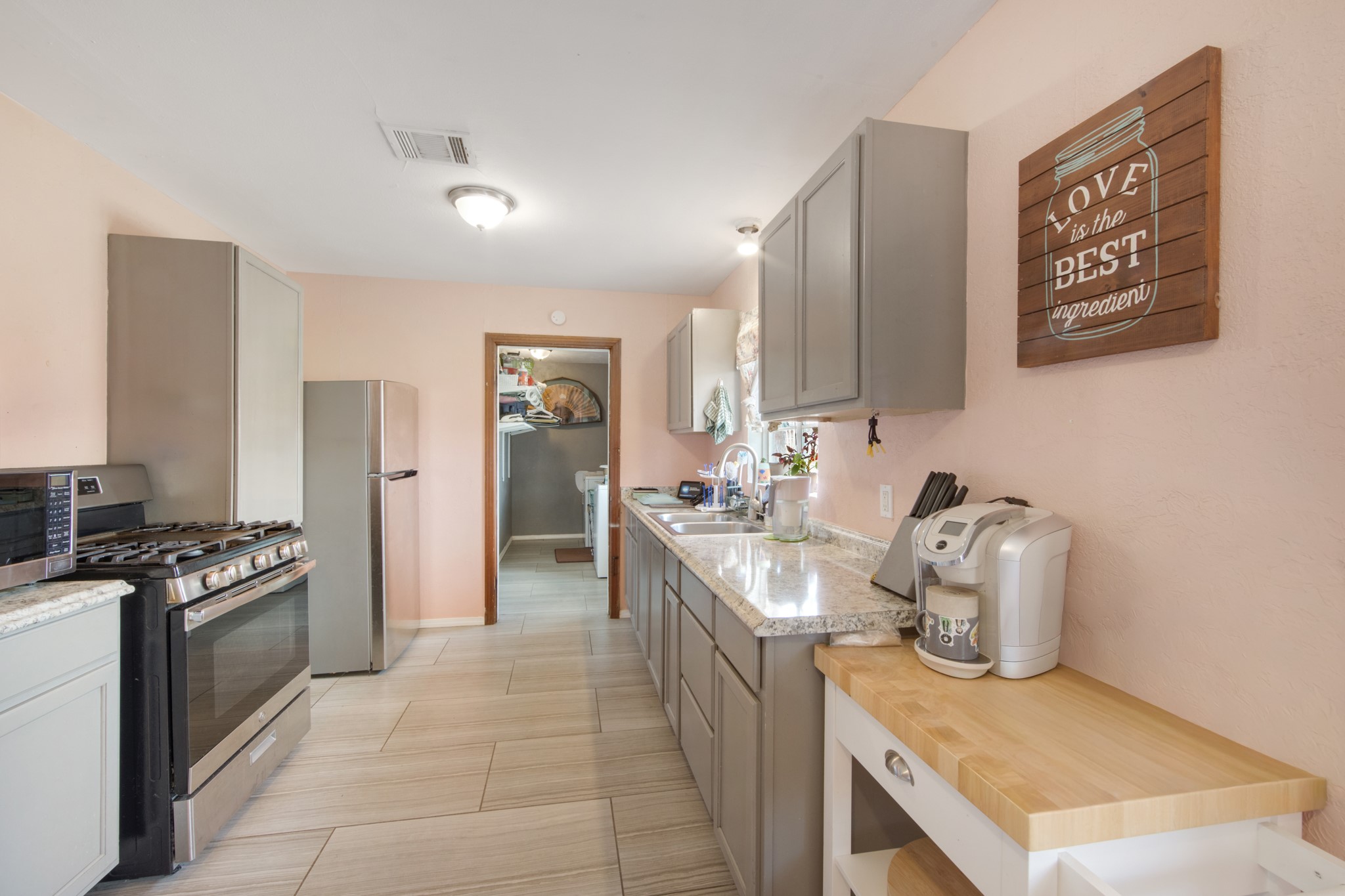 8901 Woodlyn Road Houston, TX 77078 - Photo 14 of 22 a kitchen with stainless steel appliances granite countertop a sink stove and refrigerator