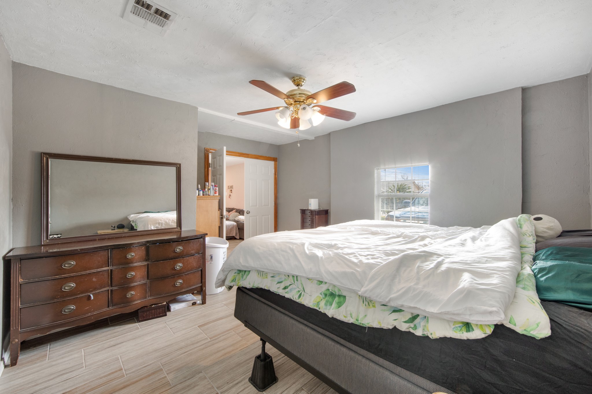 8901 Woodlyn Road Houston, TX 77078 - Photo 16 of 22 a bedroom with a bed and a dresser with mirror