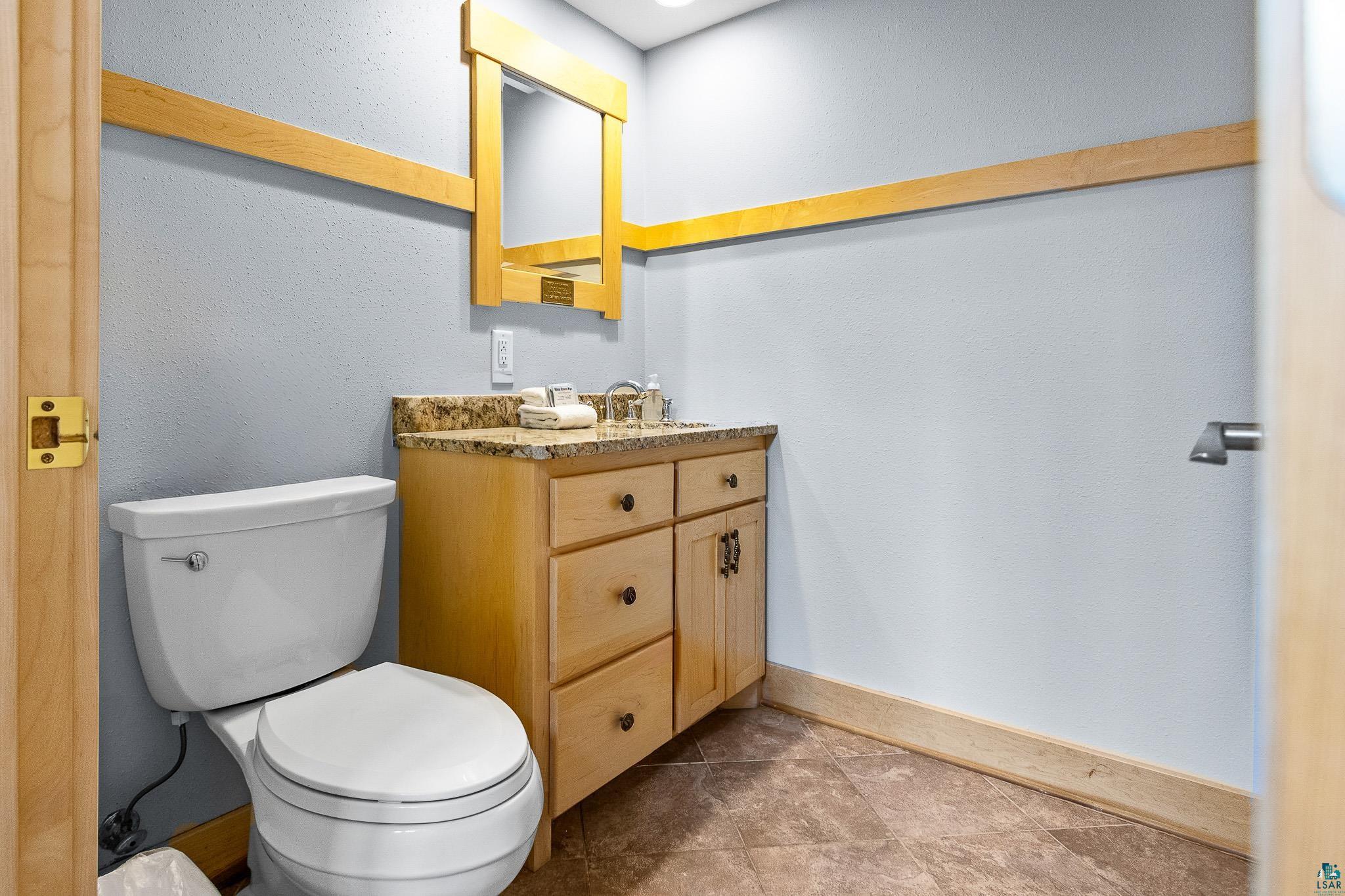 5163 Greenwood Road Duluth, MN 55804 - Photo 32 of 47 Bathroom featuring a light wood vanity with a granite countertop and an integrated sink
